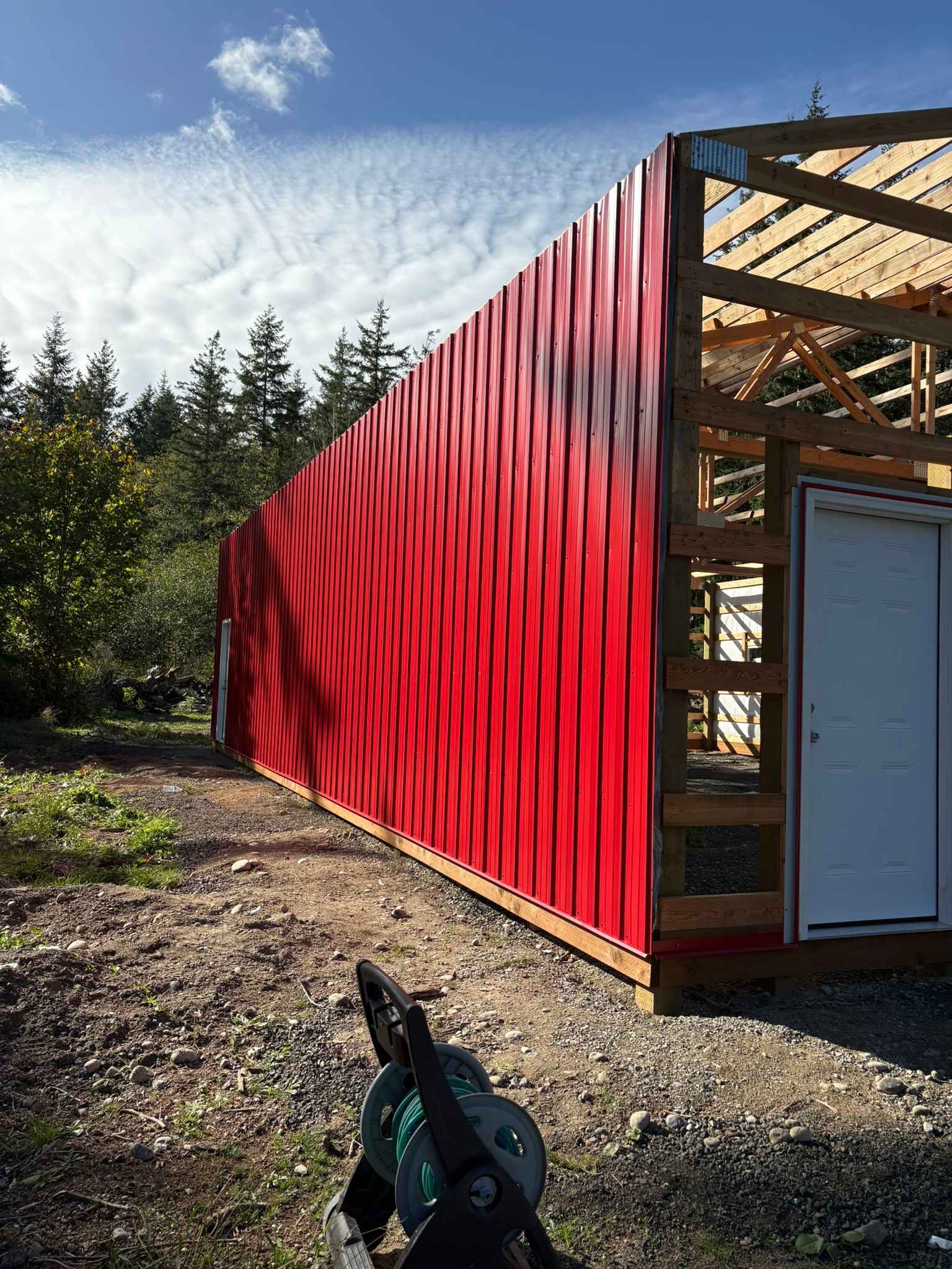 Red Siding Installation Begins