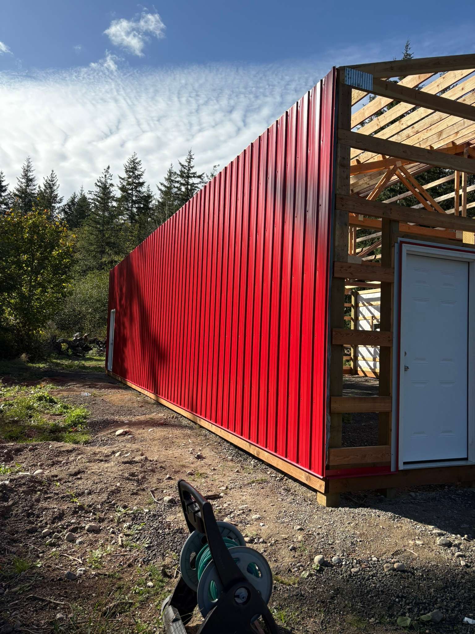 Red Siding Installation Begins